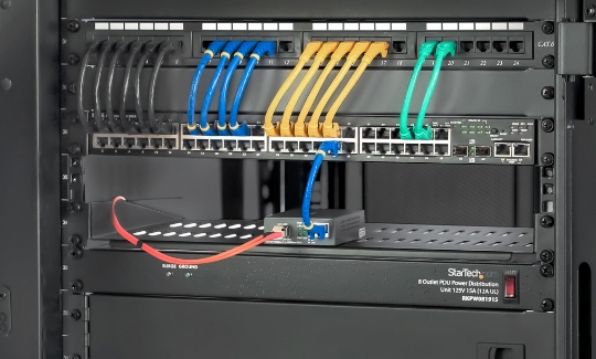 Close up of wires connected into a server on a server rack