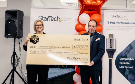 Two people holding a cheque from StarTech.com to United Way
